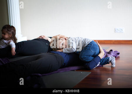 PARENT AND CHILD PRACTICING YOGA Stock Photo
