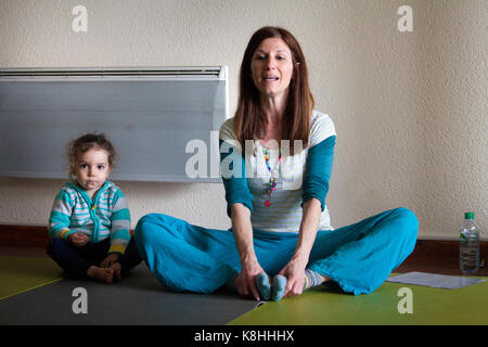 PARENT AND CHILD PRACTICING YOGA Stock Photo