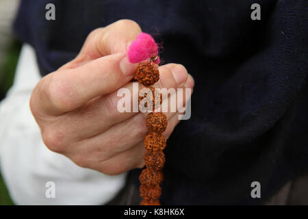 Devotee holding hindu prayer beads. gretz. france. Stock Photo