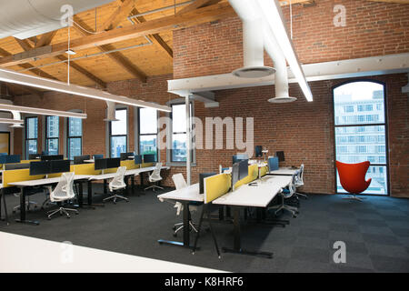 Trendy modern open concept loft office space with big windows, natural light and a layout to encourage collaboration, creativity and innovation Stock Photo