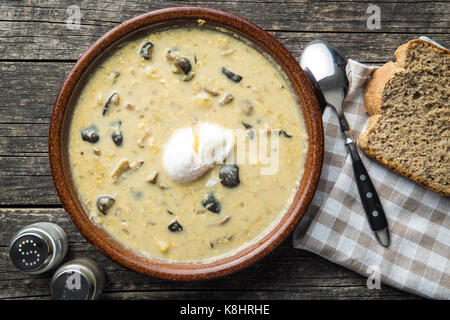 Cream of mushroom soup with poached egg. Stock Photo
