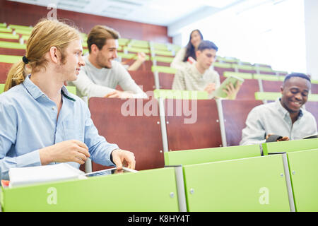 Students at university lecture hall learn together Stock Photo