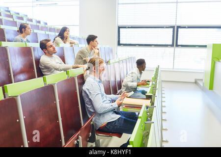 University lecture with students listening to teacher Stock Photo