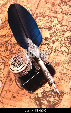 composition of pen on an ancient map Stock Photo