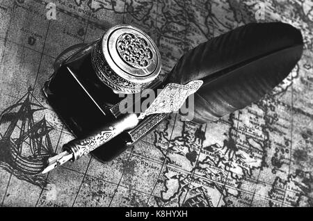 composition of pen on an ancient map Stock Photo