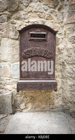 Close up view of an old decaying mailbox hanging on a wall Stock Photo