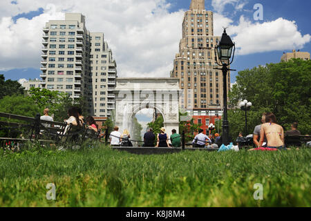 New York, NY, USA - June 1, 2017: Tourists and New York locals alike enjoy a sunny day in Washington Square Park Stock Photo
