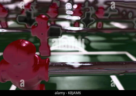 A red foosball player on a table with special effects. Stock Photo