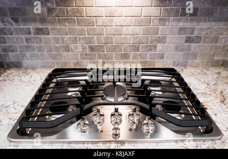 A gas stovetop on a granite countertop. Stock Photo