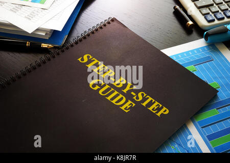 Step-by-Step Guide on a desk. Business knowledge concept. Stock Photo