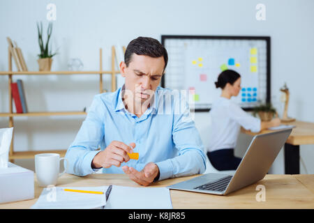 Angry brunette dropping medicine on hand Stock Photo