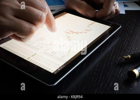 Stock trading data on a tablet screen. Stock Photo