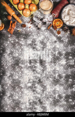 Christmas, New Year holiday cooking background. Ingredients, spices, dried oranges and baking molds, Christmas decorations (balls, fir-tree branch, co Stock Photo