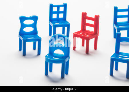 Collection of chairs with one odd one out. Stock Photo