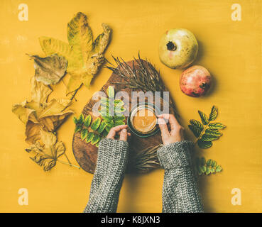 Woman' s hands in grey woolen sweater holding cup of espresso Stock Photo