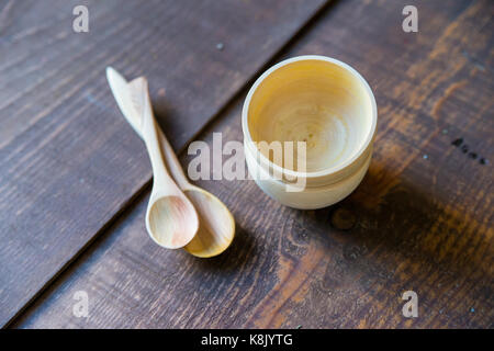 Empty wooden bowls and spoons on wooden background Stock Photo