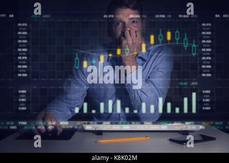 businessman analyzing stock market graphs and data on computer screen Stock Photo