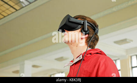 Young man in VR headset playing virtual game Stock Photo