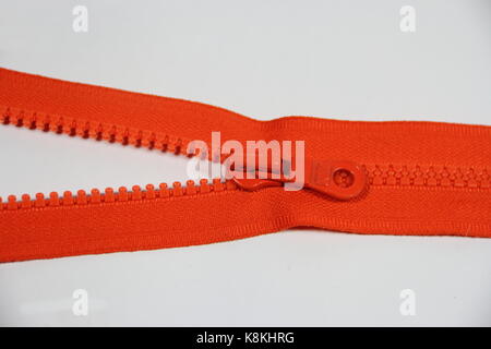 CLUTCH CLOTHING INDUSTRY ORANGE COLOR WITH WHITE BACKGROUND Stock Photo