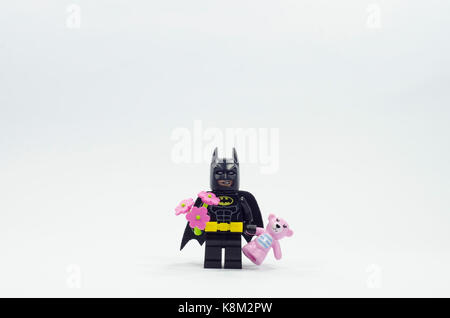 lego batman minifigure holding flower and pink teddy bear Stock Photo -  Alamy