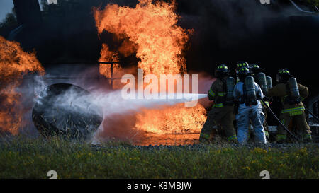 Firefighters from the 2nd Civil Engineer Squadron extinguish a fire during an aircraft live fire burn at Barksdale Air Force Base, La., Sept. 14, 2017 Stock Photo