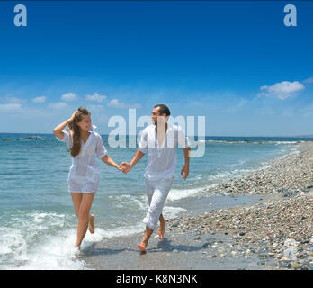 On the beach, running man and woman Stock Photo