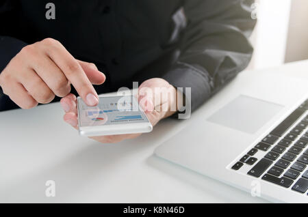 Man using mobile business report application. technology computer finance statement concept Stock Photo
