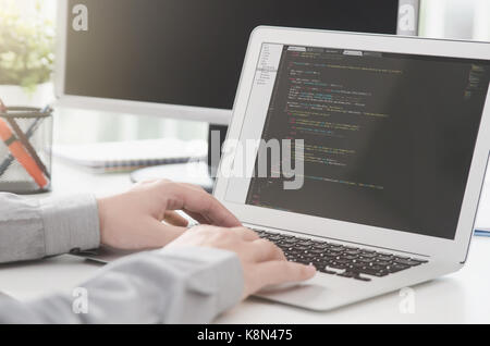 Programmer working busy software developing in company office. programmer code computer program technology office software hands on laptop concept Stock Photo
