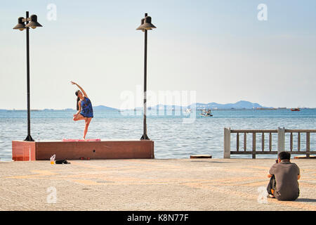Photographer with model working outdoors. Photographer shooting outside. On location. Stock Photo