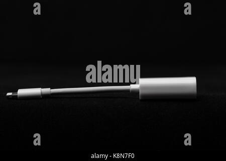 White adapter for mobile phone on black background Stock Photo