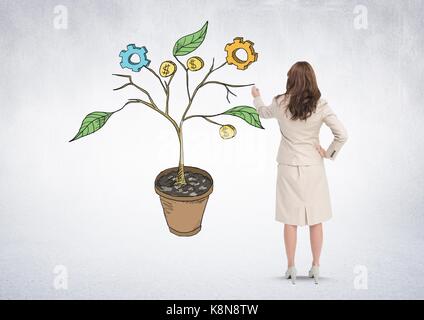Digital composite of Woman holding pen and Drawing of Business graphics on plant branches on wall Stock Photo