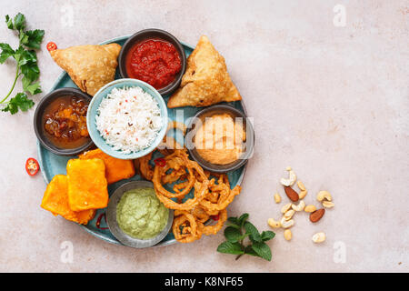Indian vegetarian thali  with jeera  rice, different snacks and dips. Top view, blank space Stock Photo