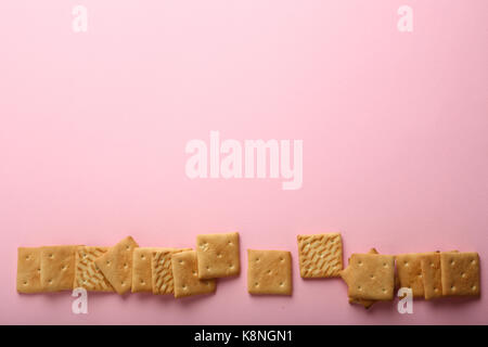 Pink cracker background, food flat lay Stock Photo