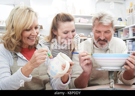 Mature Couple With Teacher In Pottery Class Stock Photo