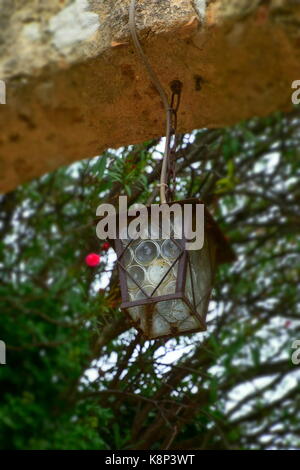old, historical, antique and rusty glass lantern in italy lantern in an archway Stock Photo