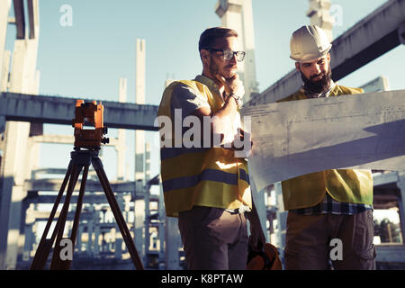 Portrait of construction engineers working on building site Stock Photo