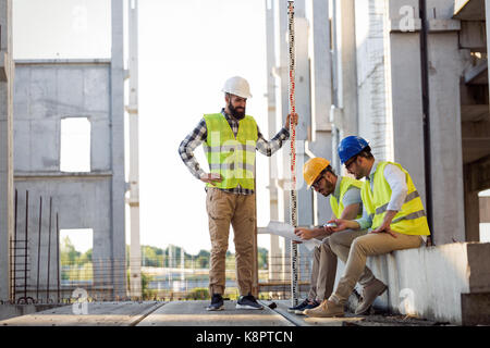 Portrait of construction engineers working on building site Stock Photo