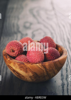 ripe lychees in wood bowl Stock Photo