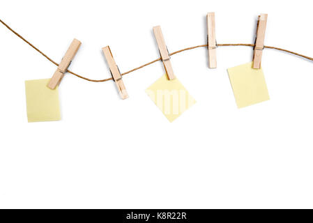 blank memo papers on rope with Clothespins, on white backgrounds. Stock Photo