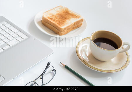 Laptop and Cup of coffee with toast, Business concept. Stock Photo