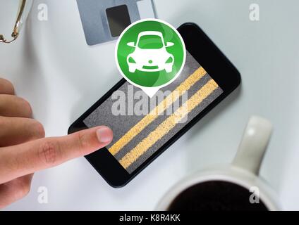 Digital composite of Hand touching phone with car icon with road Stock Photo