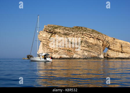 Sailing yacht anchored in front of Fungus rock, Dwejra bay, San Lawrenz, Gozo, Maltese archipelago Stock Photo