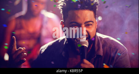 Flying colours against singer performing at illuminated nightclub Stock ...