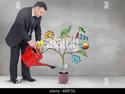 Digital composite of Man holding watering can and Drawing of Business graphics on plant branches on wall Stock Photo