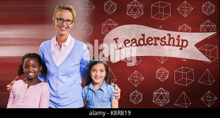 Portrait of happy teacher with students against leadership against desk Stock Photo