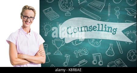 Portrait of smiling teacher against counselling against green chalkboard Stock Photo