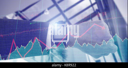 Cropped hand of businessman wearing smart watch against stocks and shares Stock Photo