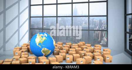 Composite image of globe amidst cardboard boxes against room with large window showing city Stock Photo