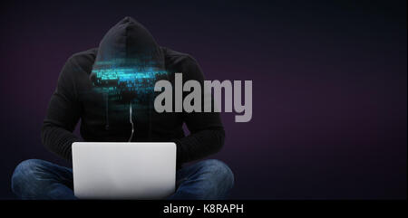 Male hacker using laptop against purple and pink background Stock Photo