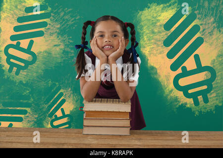 Digital composite image of light bulb on yellow spray paint against schoolgirl leaning on books stack against chalkboard in classroom Stock Photo